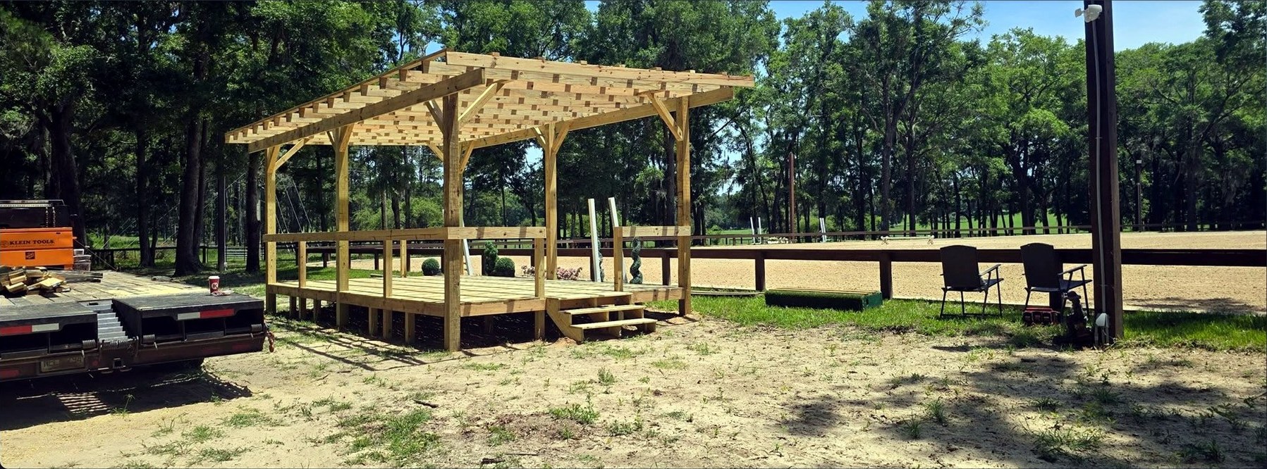 Wood pergola and raised deck under construction on a rural Florida property