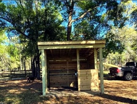 Angled view of a compact wooden farm shelter